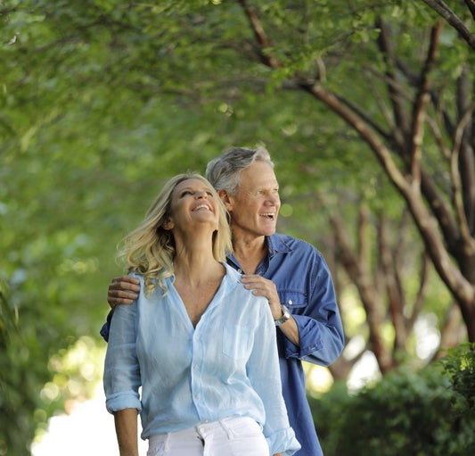 Silver Fox Hero walking with younger heroine in nature